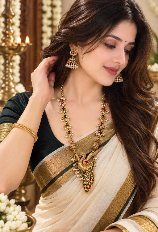 Woman wearing Veda antique gold peacock pendant necklace and Jhumka earrings