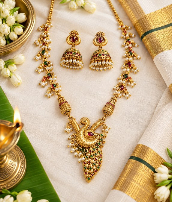Veda antique gold peacock pendant with red green stones and pearl drops